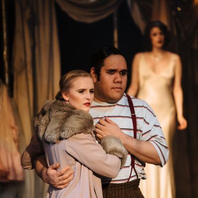 Guildhall singers hug each other while performing on stage